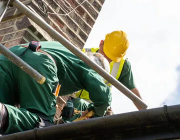 TCK Roofing and Building staff repairing a slate roof