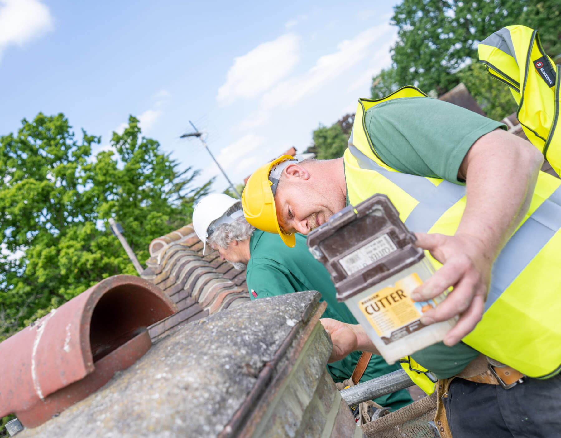 Roofer repointing a chimney in Golders Green